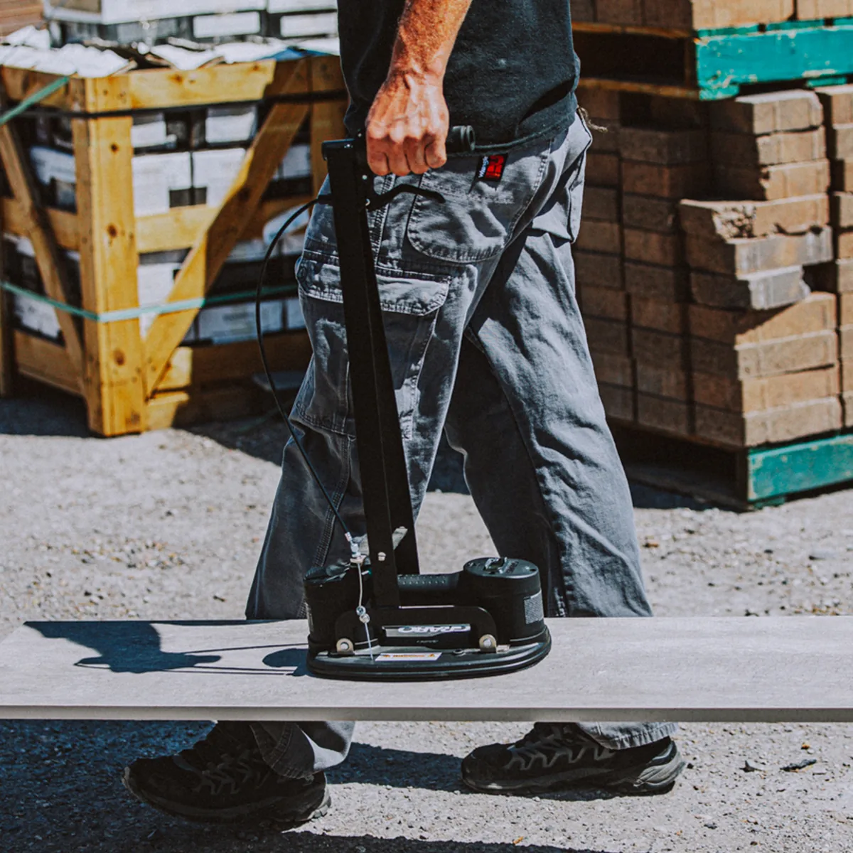 Erguo S1 carrying a paving slab across a job site