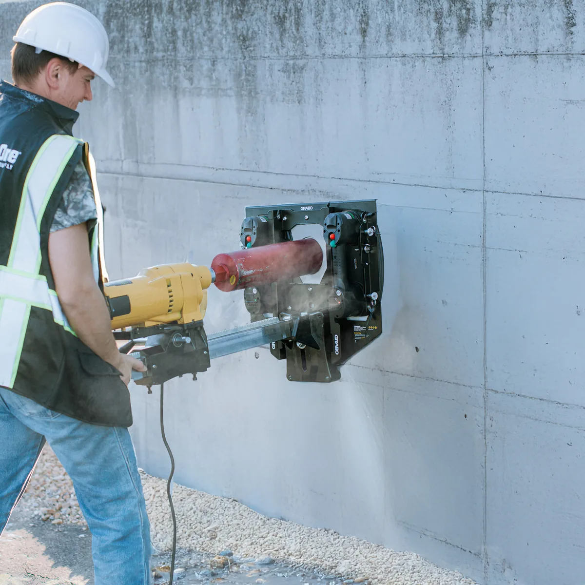 GRABO® Bore Mount holding a core drill against a concrete wall