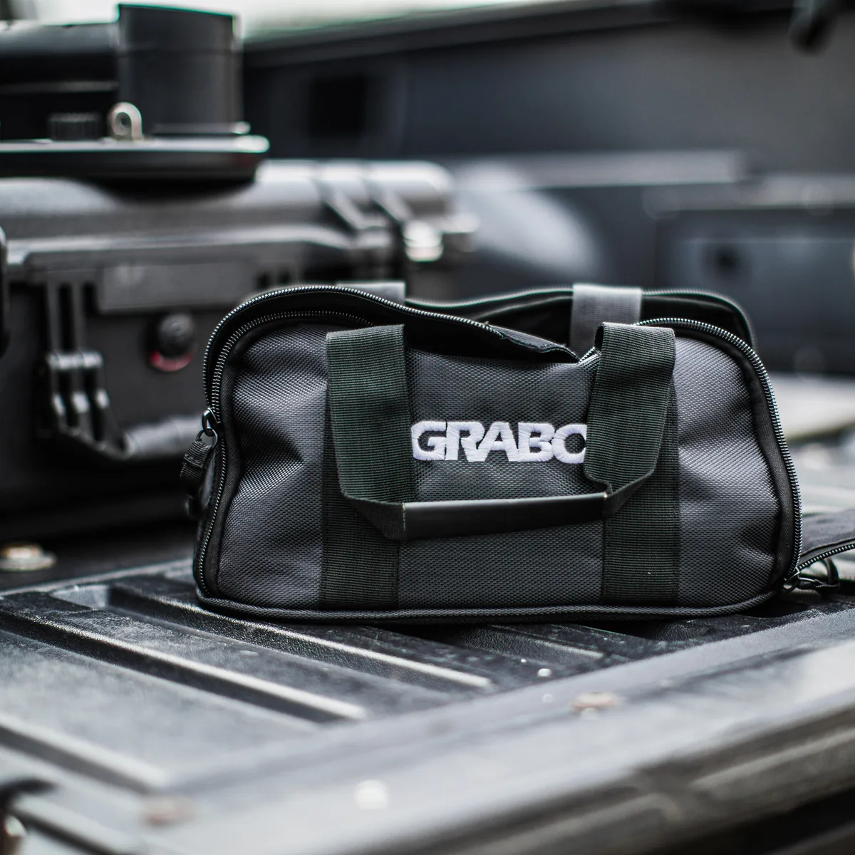 GRABO® Bag on a truck bed beside a tool case