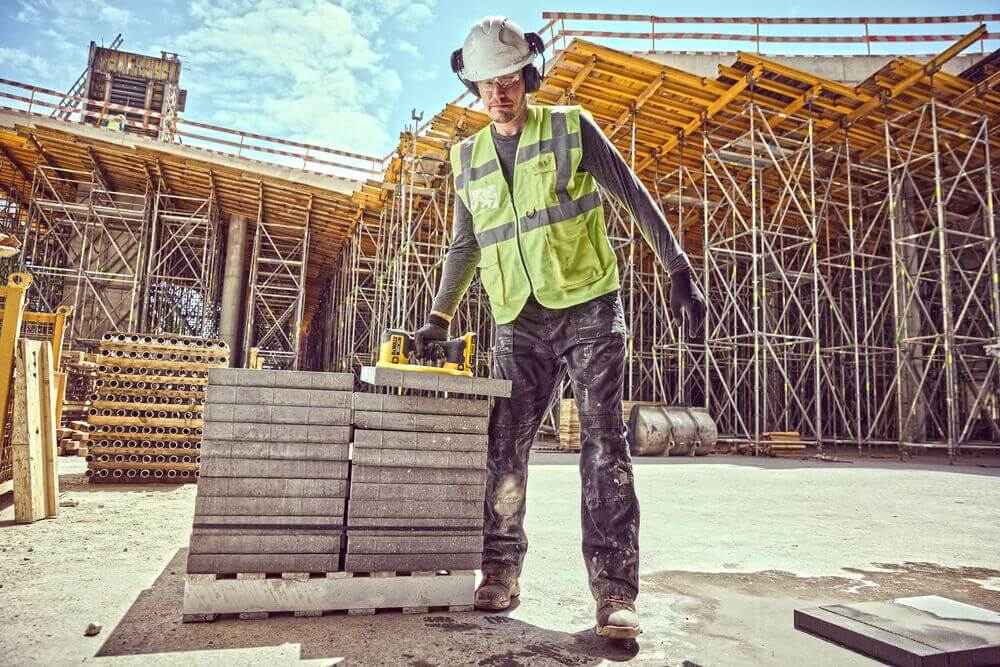 Professional using DeWalt GRABO® on a construction site